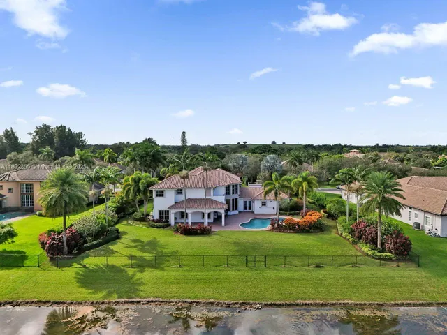 an aerial view of a house with a big yard