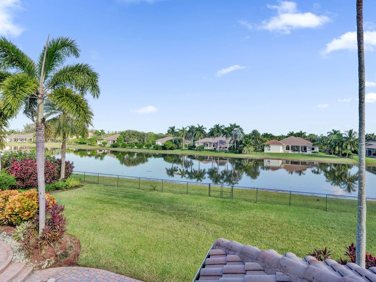 14403 Jockey Circle Davie, FL 33330 - Photo 31 of 53 a view of a lake with houses in the back