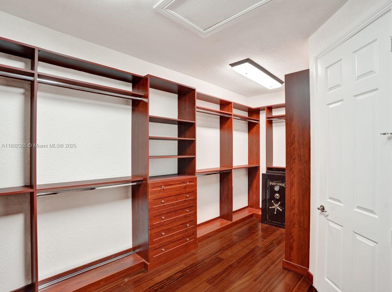 14403 Jockey Circle Davie, FL 33330 - Photo 34 of 53 a view of walk in closet with empty racks