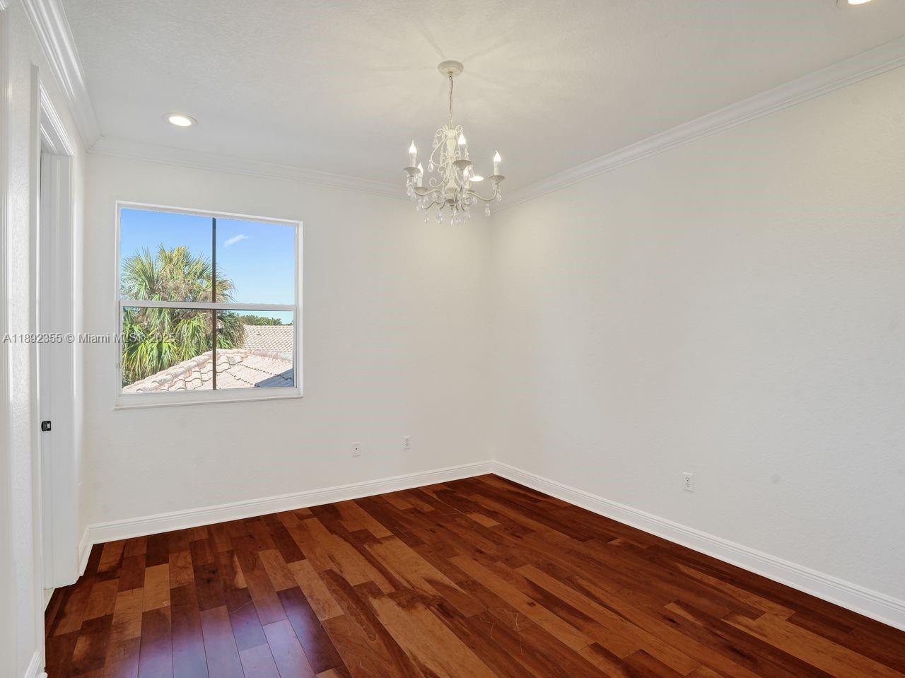 14403 Jockey Circle Davie, FL 33330 - Photo 39 of 53 a view of an empty room with wooden floor and a window