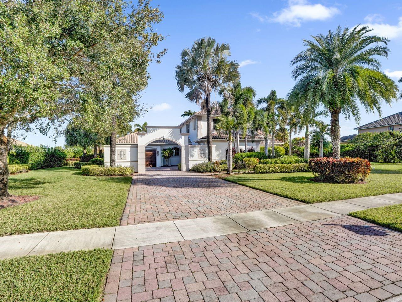 14403 Jockey Circle Davie, FL 33330 - Photo 4 of 53 a front view of a house with yard and green space