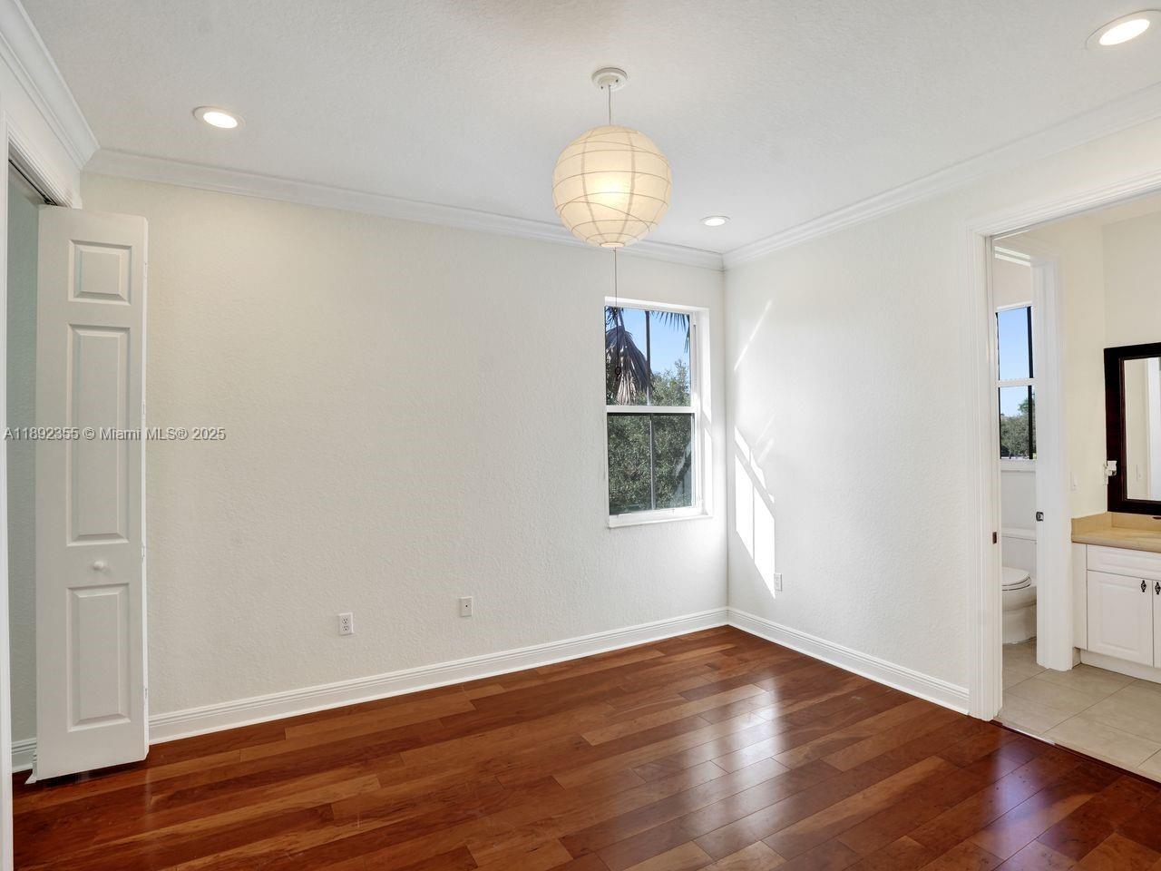 14403 Jockey Circle Davie, FL 33330 - Photo 43 of 53 an empty room with wooden floor and windows