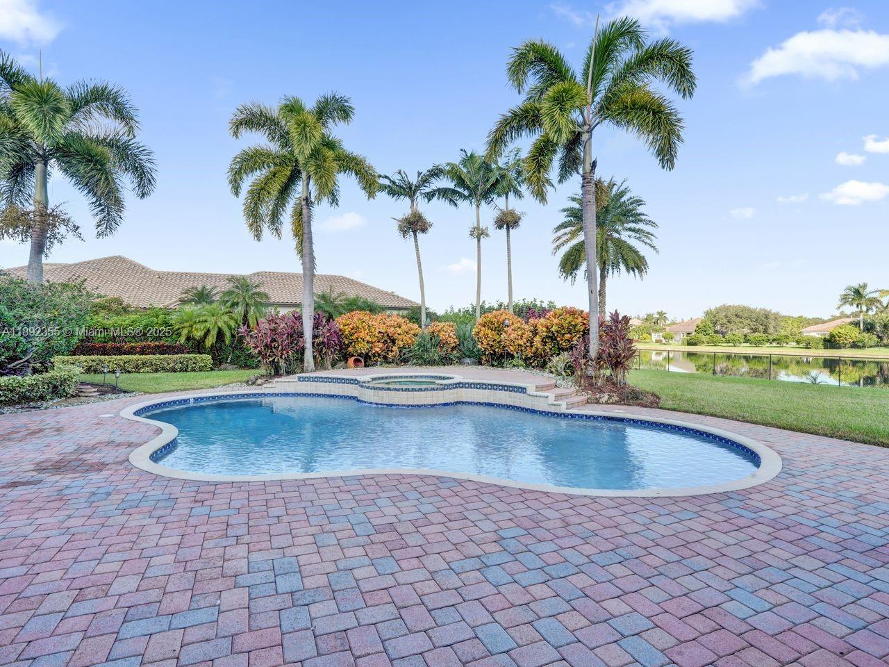 14403 Jockey Circle Davie, FL 33330 - Photo 45 of 53 a view of outdoor space with swimming pool and lake view
