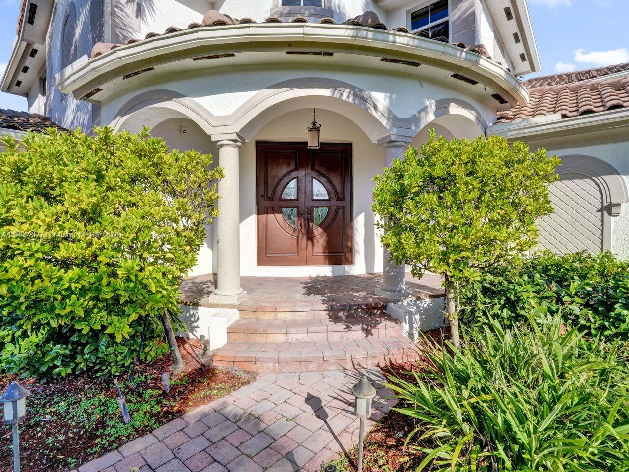 14403 Jockey Circle Davie, FL 33330 - Photo 9 of 53 a front view of a house with garden