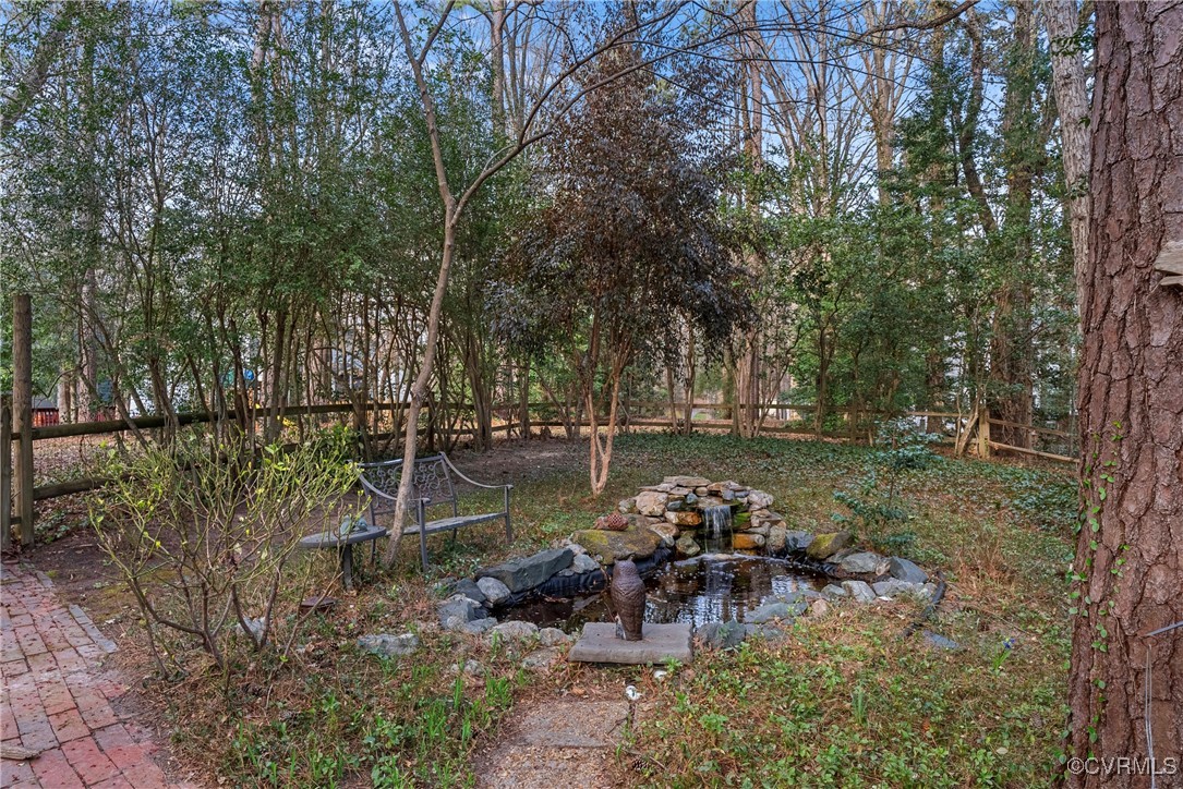 5801 Mill Spring Road Midlothian, VA 23112 - Photo 45 of 49 a view of a lake with a bench and trees