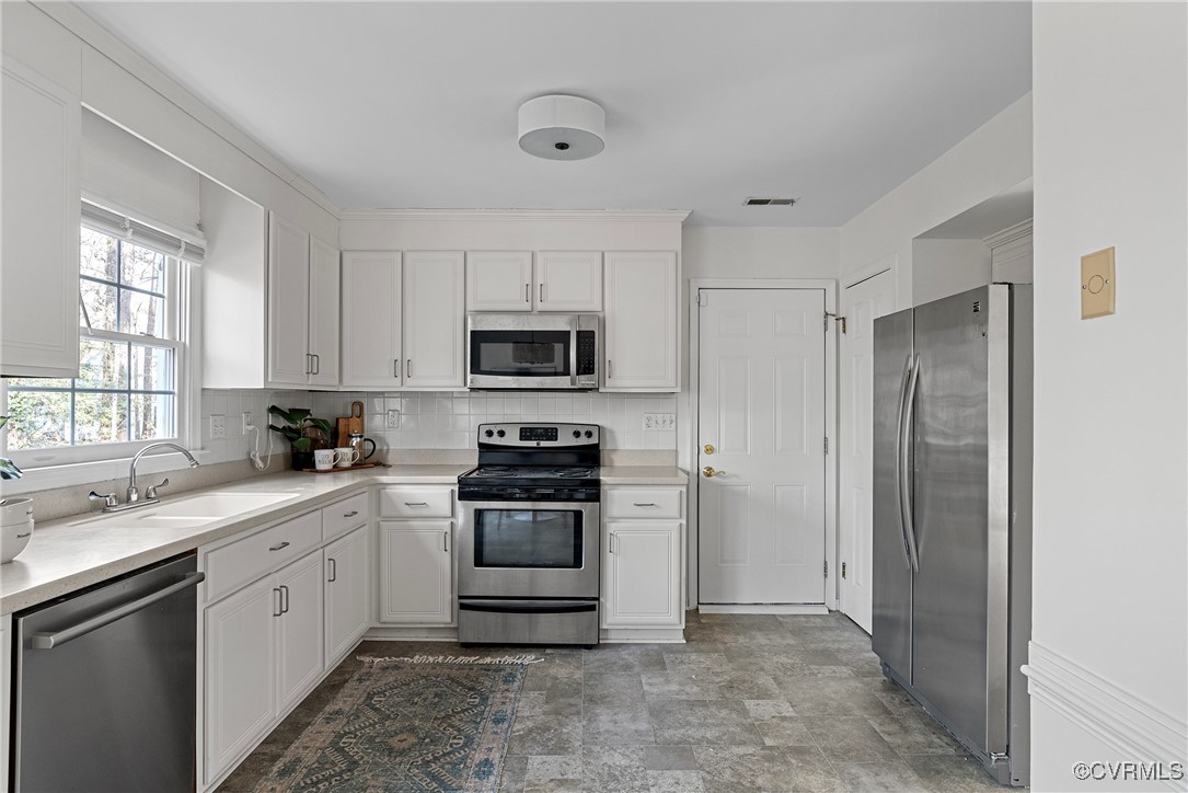 5801 Mill Spring Road Midlothian, VA 23112 - Photo 5 of 49 a kitchen with white cabinets stainless steel appliances and window