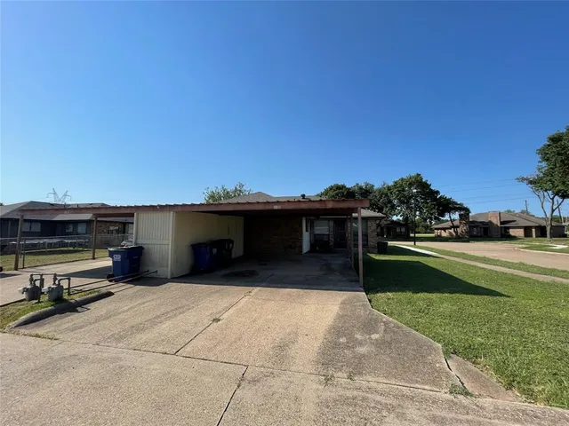 a view of a terrace with a garden and barbeque oven
