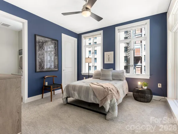 a bedroom with a bed and wall painting