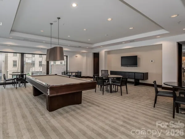 a living room with furniture a wooden floor and chandelier