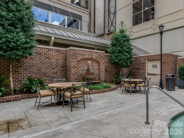 a view of a patio with table and chairs and potted plants