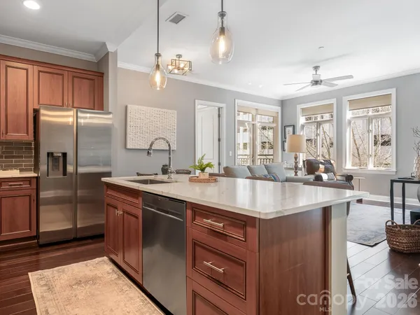 a kitchen with stainless steel appliances granite countertop a sink stove and refrigerator