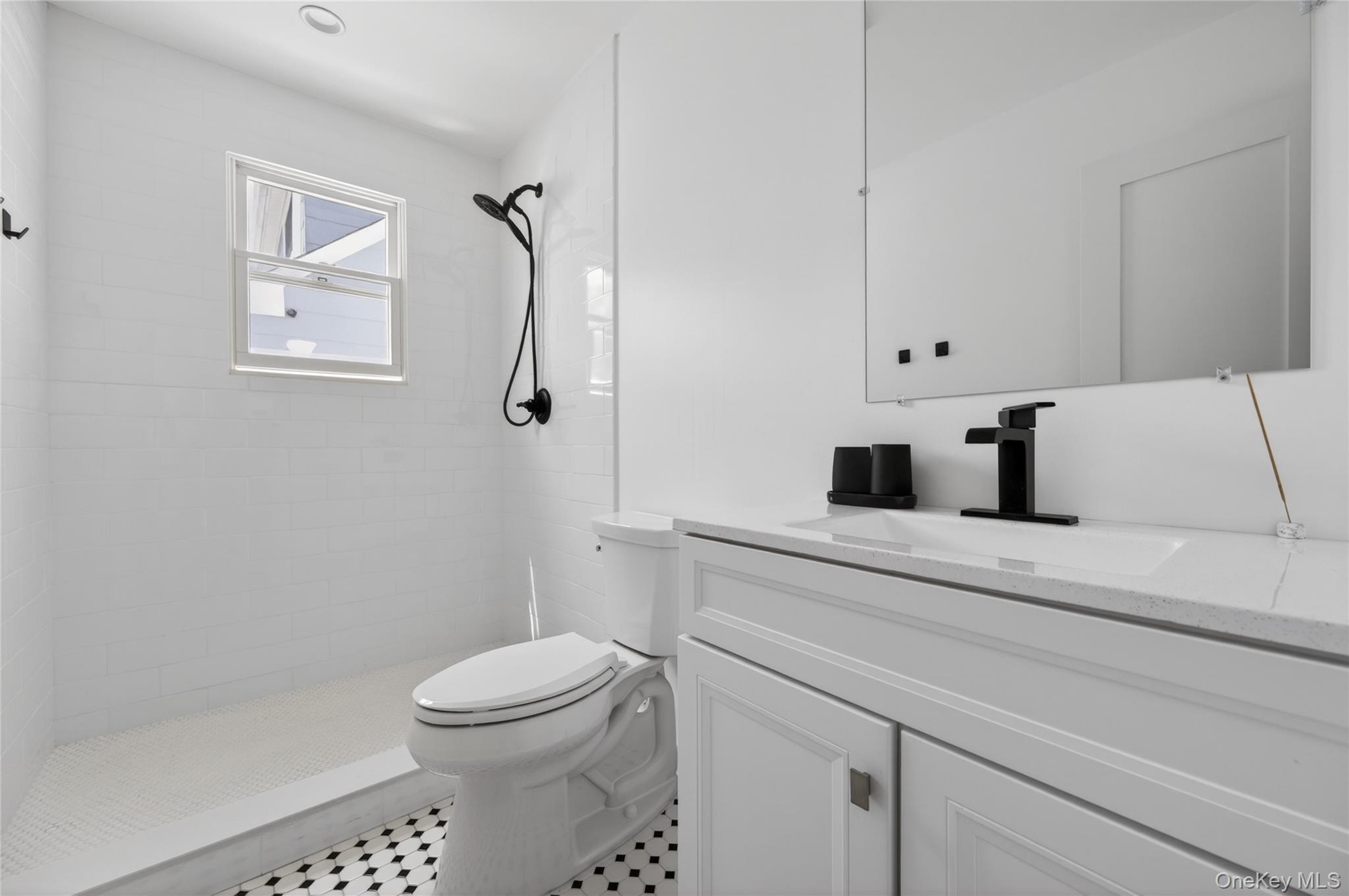 534 Riverside Avenue Massapequa, NY 11758 - Photo 13 of 28 a bathroom with a toilet sink and shower