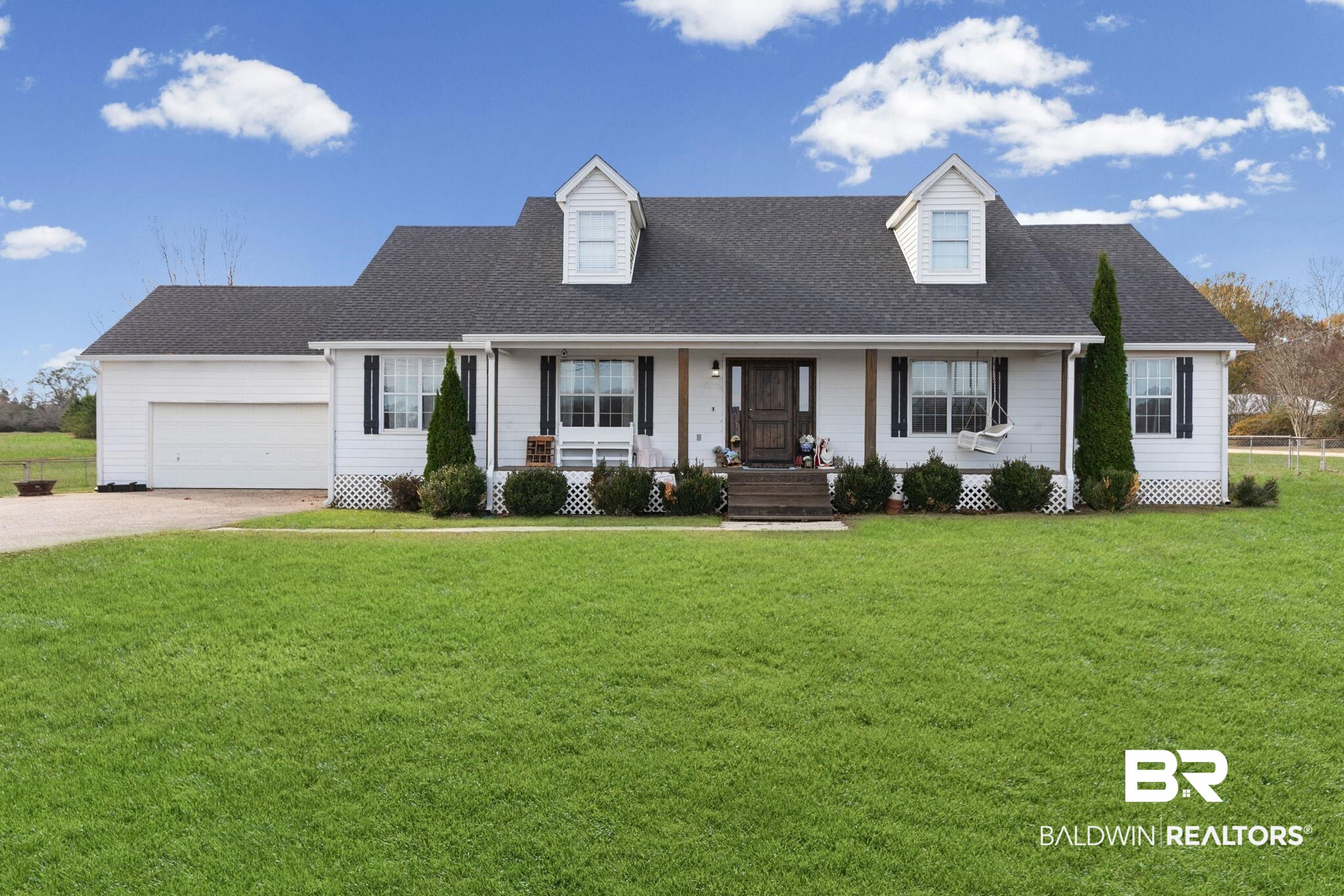 3842 Experiment Farm Road Monroeville, AL 36460 - Photo 1 of 59 Cape cod home featuring a shingled roof, covered porch, a front lawn, and driveway