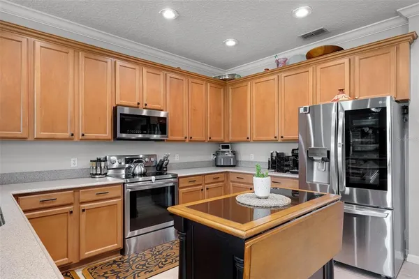 a kitchen with a sink stove and cabinets