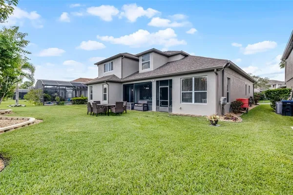 a view of a house with a yard and sitting area