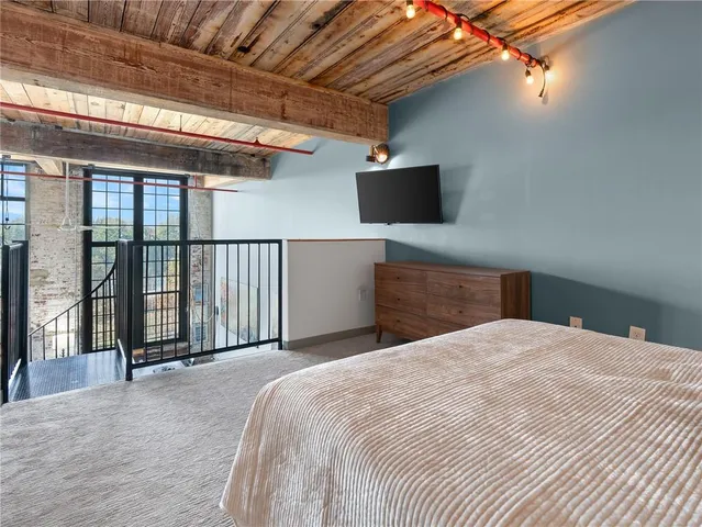 a bedroom with a bed and a television