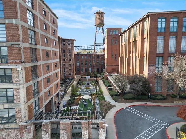 a view of a building with garden and sitting area