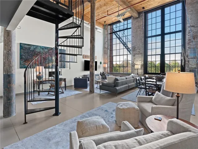 a living room with furniture and a floor to ceiling window