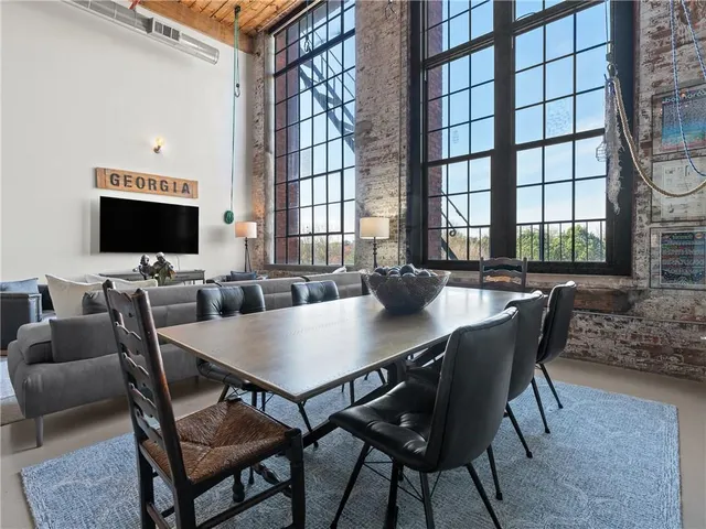 a view of a dining room with furniture and a floor to ceiling window
