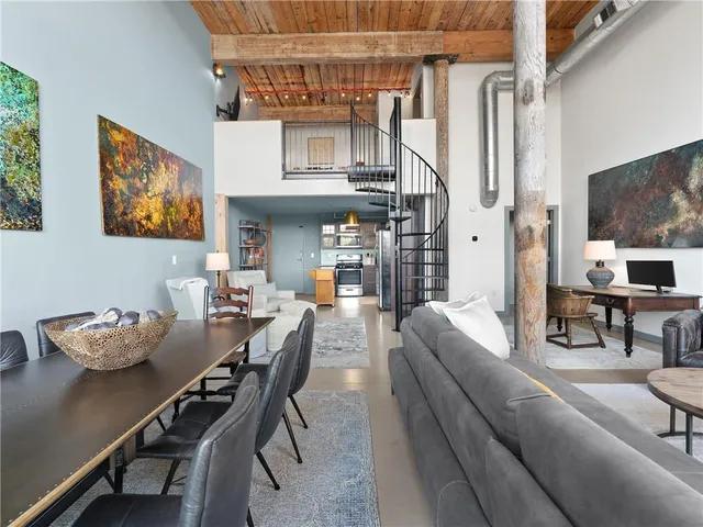 a dining room with furniture and a chandelier