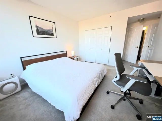 a bedroom with a bed and a chair