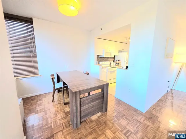 a dining room with a table and chairs