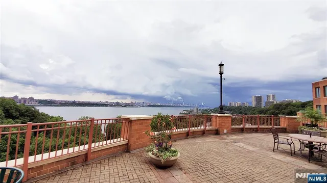 a view of a terrace with lawn chairs