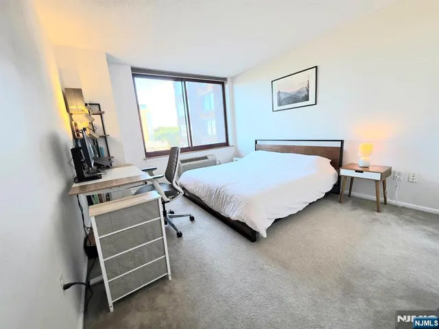 a bedroom with a bed and a desk