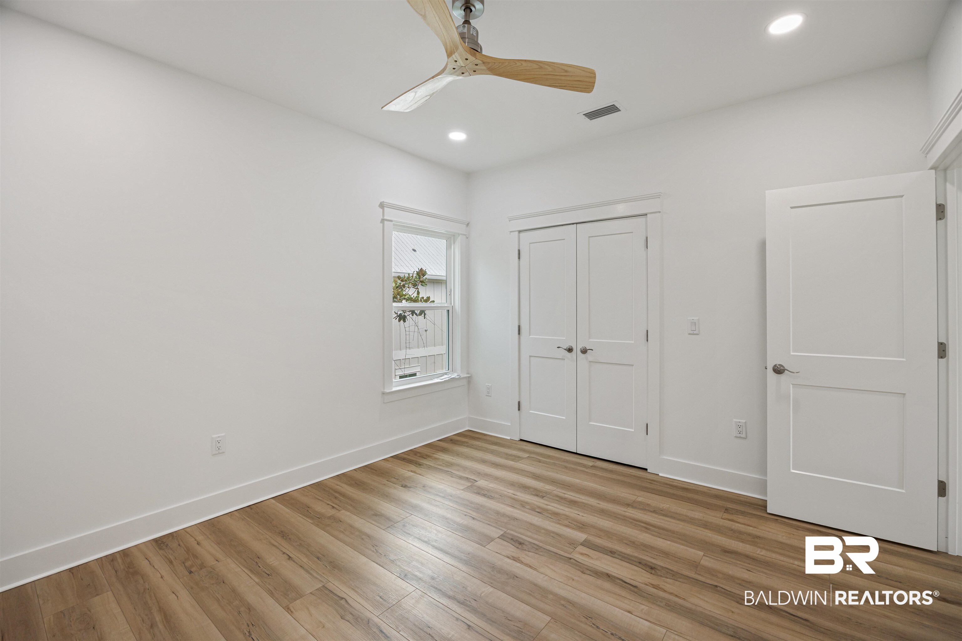 27591 Canal Road Orange Beach, AL 36561 - Photo 34 of 51 Unfurnished bedroom featuring recessed lighting, light wood finished floors, ceiling fan, and a closet