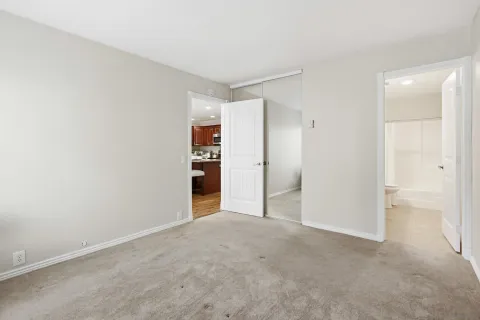 a view of an empty room and closet area