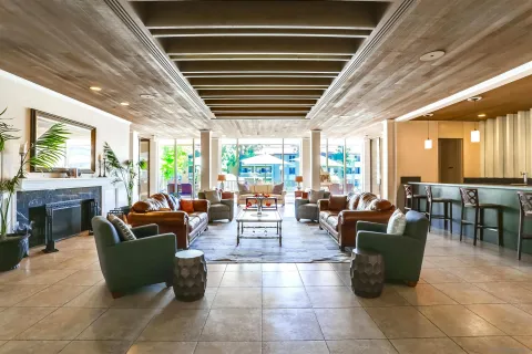 a living room with fireplace furniture and a large window