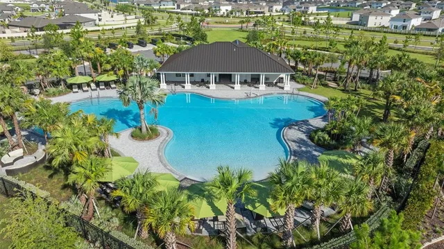 a aerial view of a house with a yard and lake view