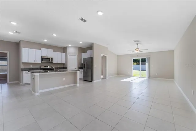 a large kitchen with cabinets and stainless steel appliances
