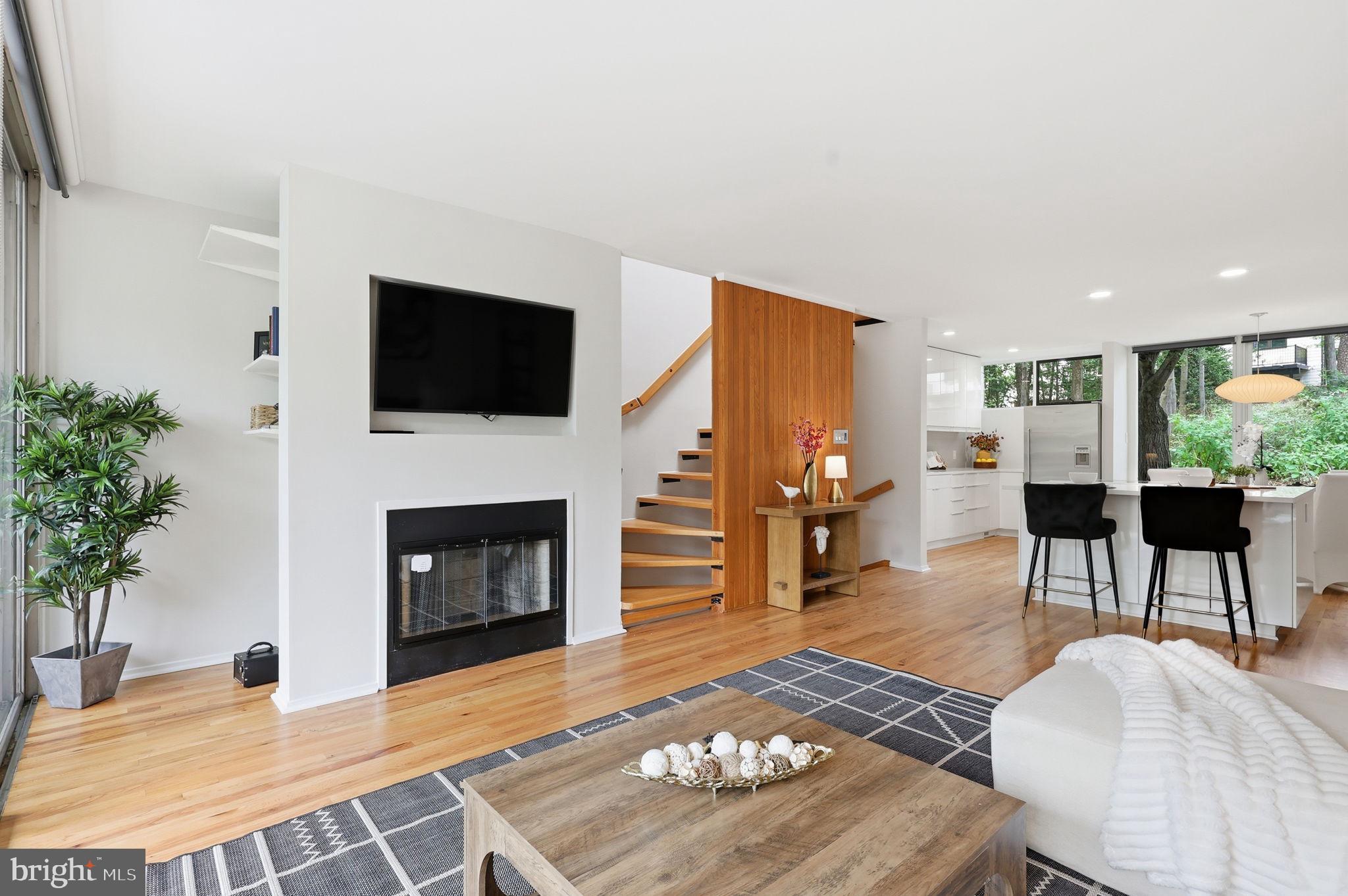 11510 Maple Ridge Road Reston, VA 20190 - Photo 11 of 43 a living room with furniture a fireplace and a flat screen tv