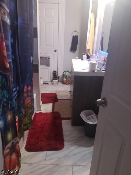 426 Cornelia Street, Unit 1 Boonton, NJ 07005 - Photo 7 of 7 a bathroom with a sink toilet and mirror