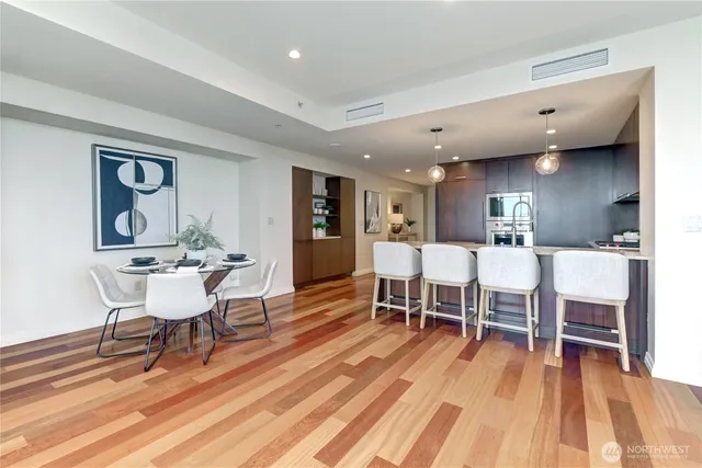 a dining room with furniture and wooden floor