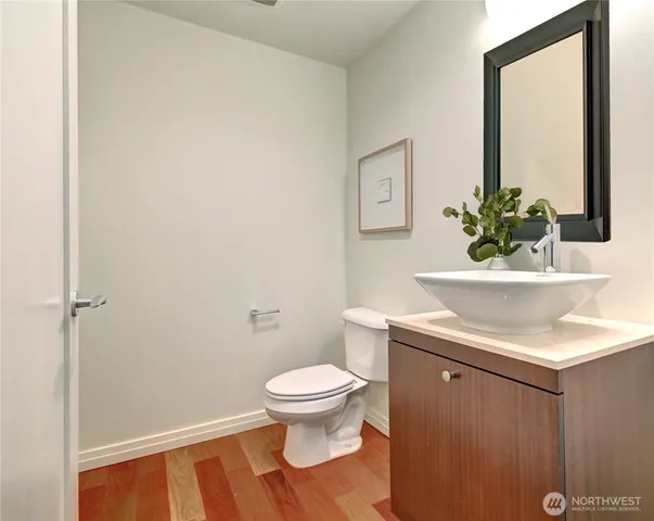 a bathroom with a sink a toilet and a mirror