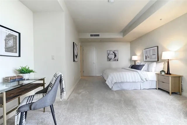 a bedroom with a bed and a couch