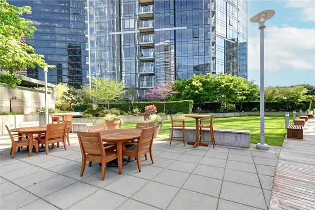 a view of a chairs and table in the patio with a swimming pool