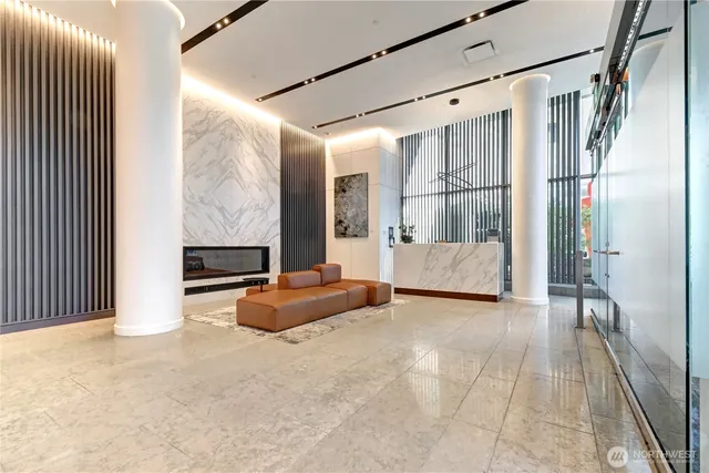 a spacious bedroom with a large bed and a chandelier