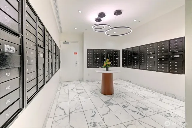 a view of a dining room with a large window and chandelier