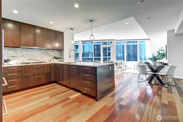a kitchen with stainless steel appliances kitchen island granite countertop a stove and a wooden cabinets