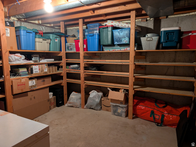 1411 Millbrook Way Bountiful, UT 84010 - Photo 35 of 36 Unfinished basement area featuring extensive built-in wooden shelving for ample storage.