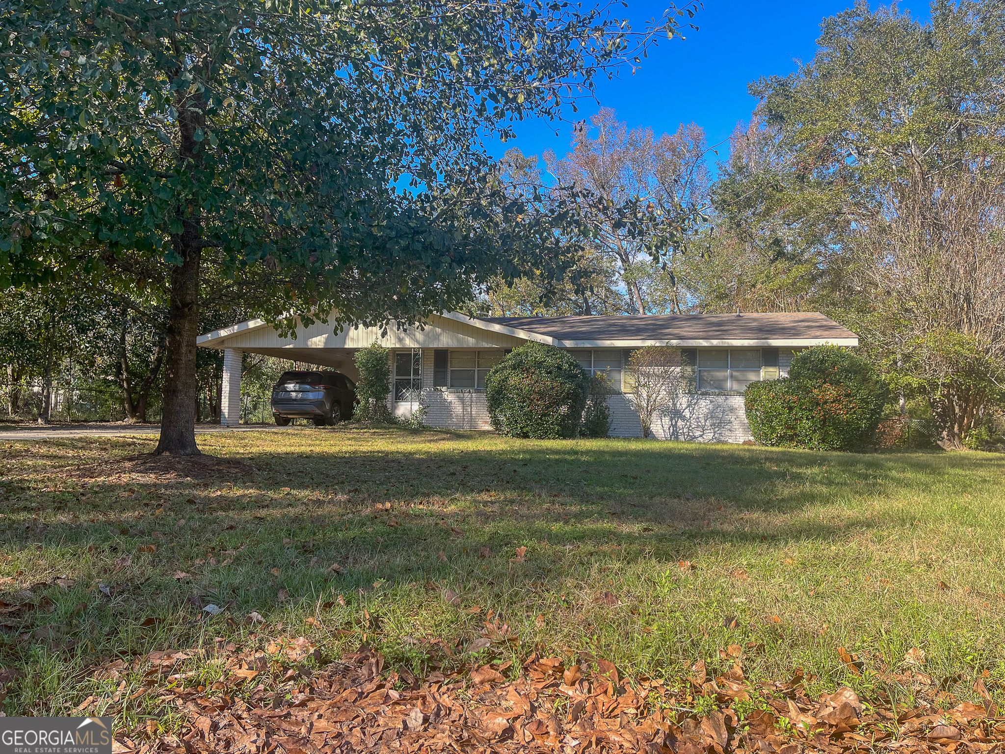 100 Maple Street Dublin, GA 31021 - Photo 1 of 1 a view of a fountain in front of a house with large trees