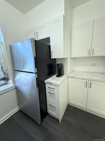 a utility room with cabinets washer and dryer