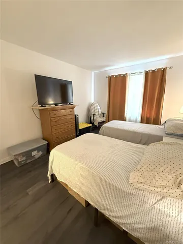 a bedroom with a bed and flat screen tv