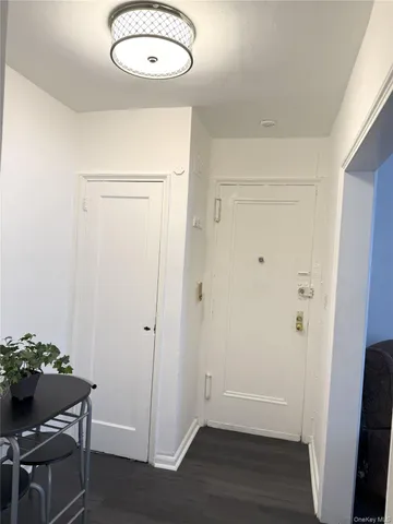 a view of a room with wooden floor