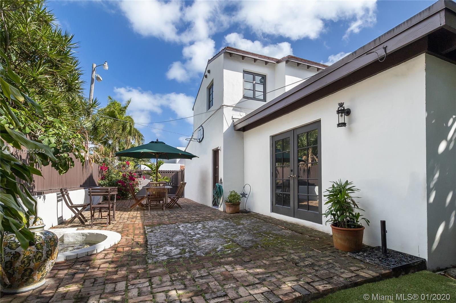 4770 Alton Road Miami Beach, FL 33140 - Photo 4 of 24 backyard with fountain and patio