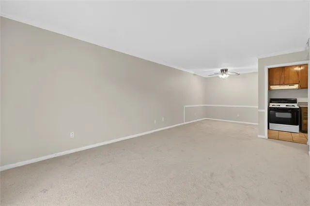 a view of an empty room with a kitchen