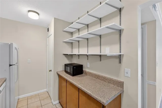 a kitchen with cabinets and white appliances